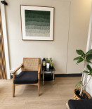 Seating area with plants and artwork at 7 Day Spa