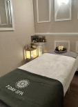 Massage treatment bed with fresh towels at 7 Day Spa